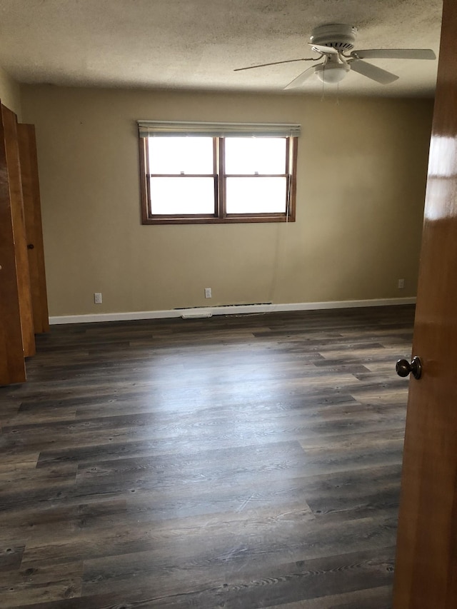 233 W Chestnut St, Puryear, TN 38251 - spare room with healthy amount of natural light, ceiling fan, and dark wood-type flooring