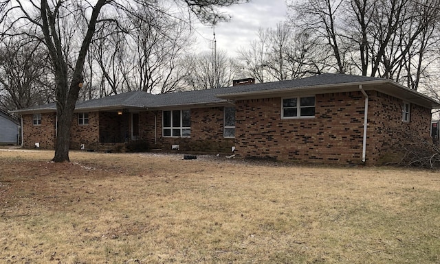 233 W Chestnut St, Puryear, TN 38251 - single story home featuring brick siding, a front yard, and a chimney