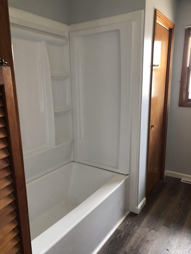 233 W Chestnut St, Puryear, TN 38251 - full bathroom with wood finished floors and tub / shower combination