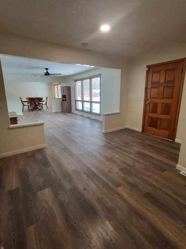 233 W Chestnut St, Puryear, TN 38251 - unfurnished living room with dark wood finished floors, ceiling fan, and recessed lighting