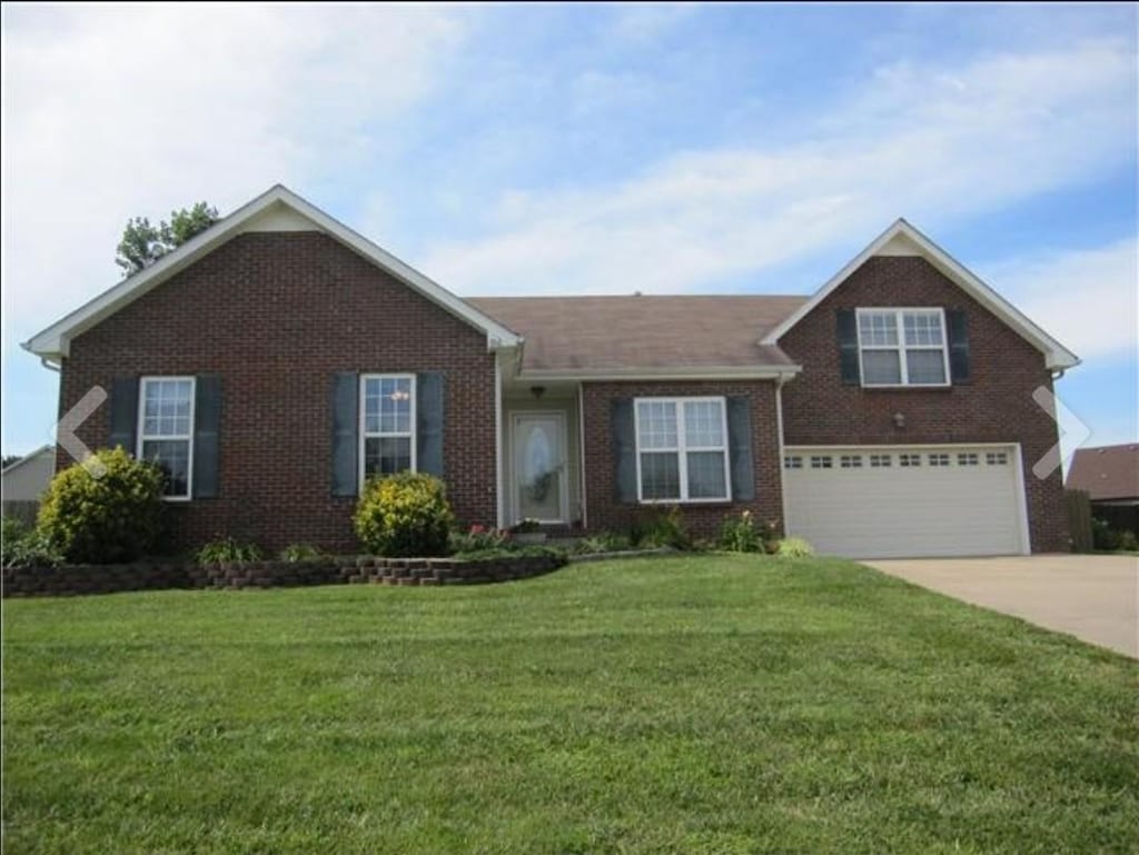 366 Woodtrace Dr, Clarksville, TN 37042 - view of front of property featuring brick siding, an attached garage, concrete driveway, and a front yard