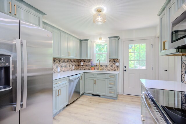 445 High Point Rd, Clarksville, TN 37042 - kitchen featuring stainless steel appliances, light wood-style flooring, backsplash, light countertops, and gray cabinetry