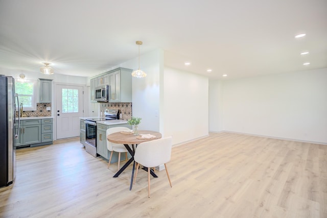 445 High Point Rd, Clarksville, TN 37042 - kitchen with stainless steel appliances, light wood-type flooring, decorative backsplash, light countertops, and recessed lighting