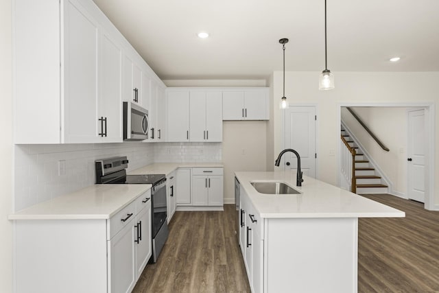 4026 Rampart Way, Spring Hill, TN 37174 - kitchen with stainless steel appliances, dark wood-type flooring, tasteful backsplash, white cabinetry, and recessed lighting