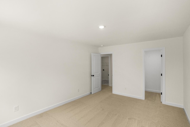 4026 Rampart Way, Spring Hill, TN 37174 - unfurnished bedroom featuring a spacious closet, light colored carpet, and recessed lighting