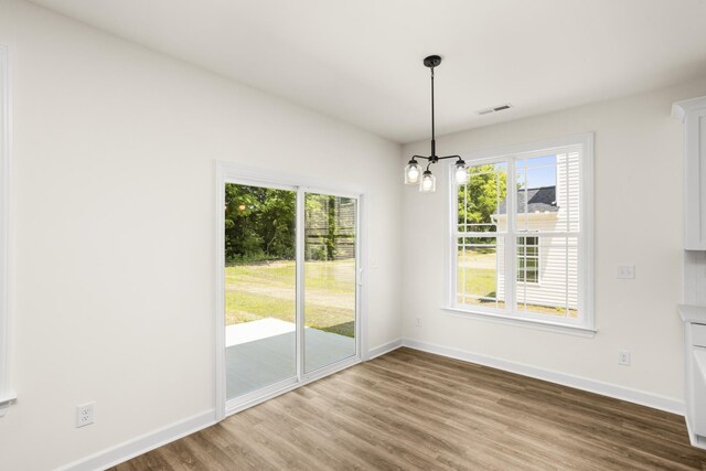 4026 Rampart Way, Spring Hill, TN 37174 - unfurnished dining area with a chandelier, plenty of natural light, and wood finished floors