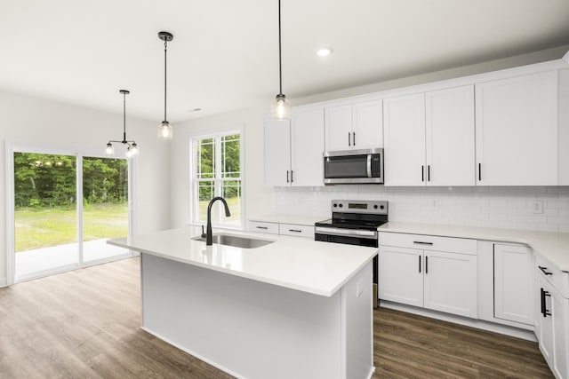 4026 Rampart Way, Spring Hill, TN 37174 - kitchen with stainless steel appliances, tasteful backsplash, light countertops, dark wood-style flooring, and white cabinetry