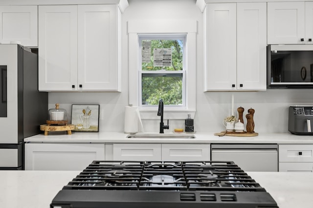 2117 Strombury Dr, Hermitage, TN 37076 - kitchen with appliances with stainless steel finishes, white cabinetry, and light countertops