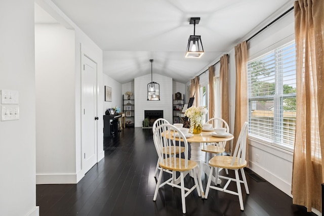 2117 Strombury Dr, Hermitage, TN 37076 - dining area featuring vaulted ceiling, dark wood-type flooring, a brick fireplace, and plenty of natural light