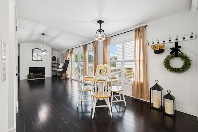 2117 Strombury Dr, Hermitage, TN 37076 - dining space featuring a fireplace, dark wood finished floors, and vaulted ceiling