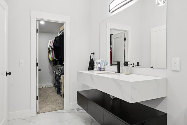 2117 Strombury Dr, Hermitage, TN 37076 - bathroom featuring a walk in closet, vanity, and marble finish flooring