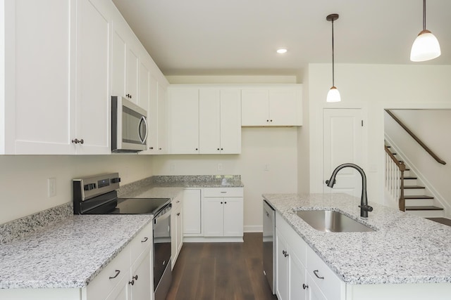 4020 Rampart Way, Spring Hill, TN 37174 - kitchen with appliances with stainless steel finishes, an island with sink, dark wood finished floors, white cabinets, and recessed lighting