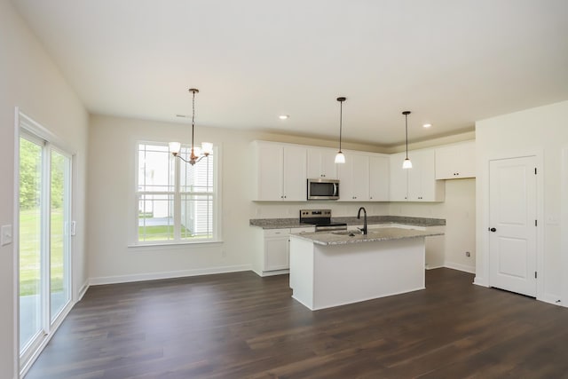 4020 Rampart Way, Spring Hill, TN 37174 - kitchen featuring appliances with stainless steel finishes, light stone countertops, dark wood-style floors, a kitchen island with sink, and recessed lighting