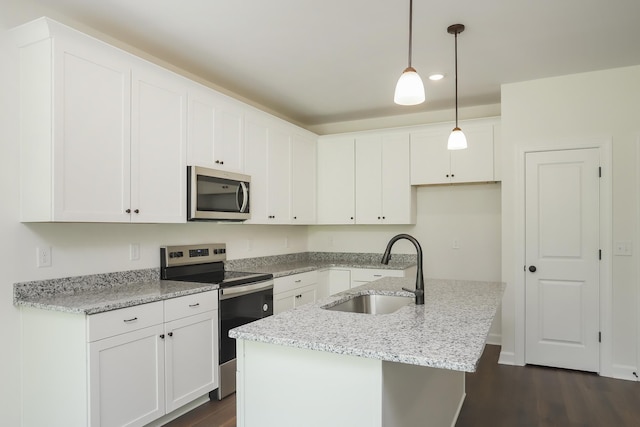 4020 Rampart Way, Spring Hill, TN 37174 - kitchen featuring appliances with stainless steel finishes, dark wood-style floors, white cabinetry, a kitchen island with sink, and hanging light fixtures