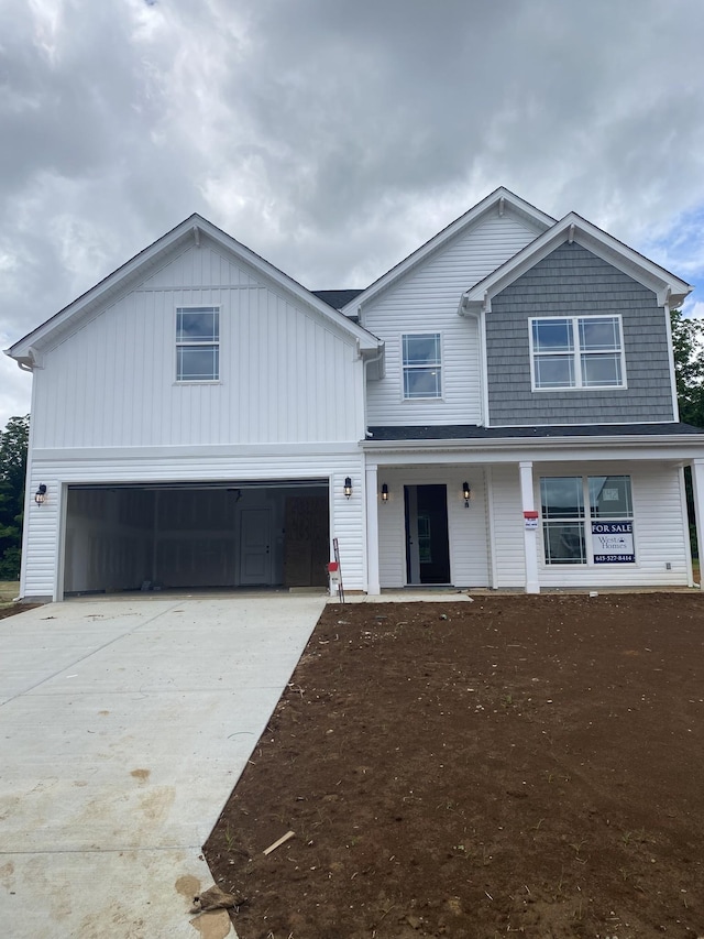 4020 Rampart Way, Spring Hill, TN 37174 - view of front of home featuring covered porch, a garage, concrete driveway, and board and batten siding