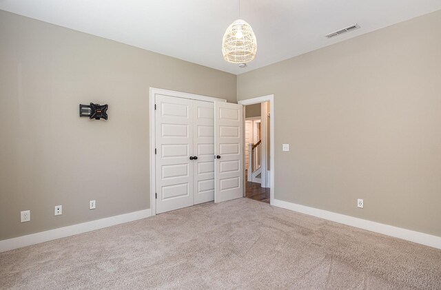 2050 Beamon Dr, Franklin, TN 37064 - unfurnished bedroom featuring carpet floors, a closet, and a chandelier