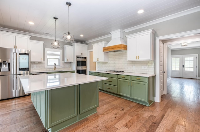 2050 Beamon Dr, Franklin, TN 37064 - kitchen featuring green cabinets, stainless steel appliances, custom range hood, white cabinetry, and a center island