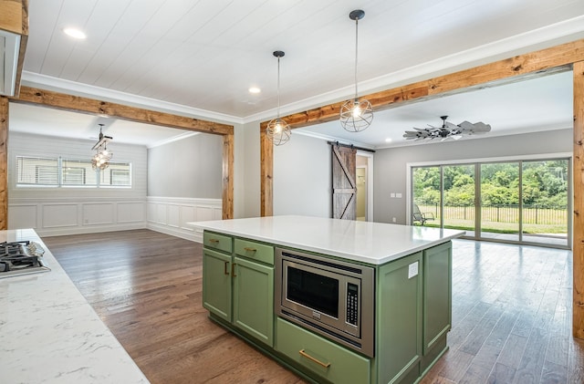 2050 Beamon Dr, Franklin, TN 37064 - kitchen featuring green cabinets, stainless steel appliances, a barn door, plenty of natural light, and ornamental molding