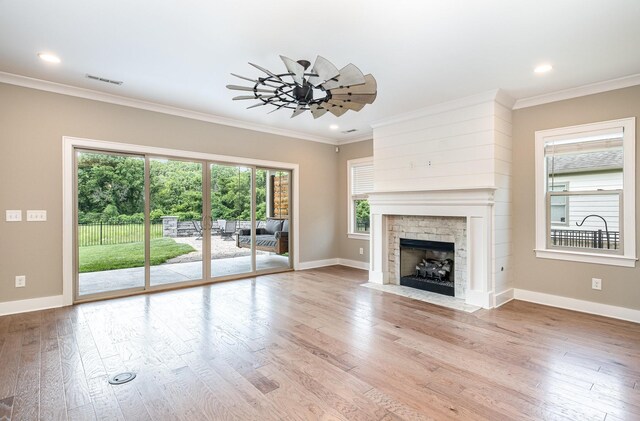 2050 Beamon Dr, Franklin, TN 37064 - unfurnished living room with crown molding, wood finished floors, a fireplace with flush hearth, and recessed lighting
