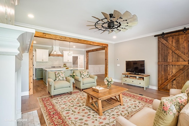 2050 Beamon Dr, Franklin, TN 37064 - living room featuring crown molding, a barn door, light wood-style flooring, ceiling fan, and recessed lighting