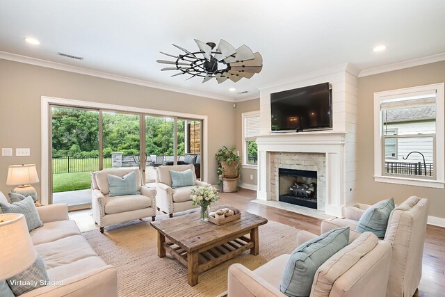 2050 Beamon Dr, Franklin, TN 37064 - living room featuring wood finished floors, ornamental molding, recessed lighting, and a fireplace with flush hearth