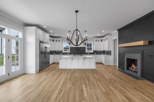 5937 Hunt Valley Dr, Spring Hill, TN 37174 - kitchen featuring stainless steel built in refrigerator, light countertops, decorative backsplash, a chandelier, and white cabinets