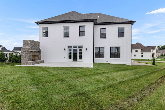5937 Hunt Valley Dr, Spring Hill, TN 37174 - rear view of property with an outdoor stone fireplace, a patio area, a lawn, and roof with shingles