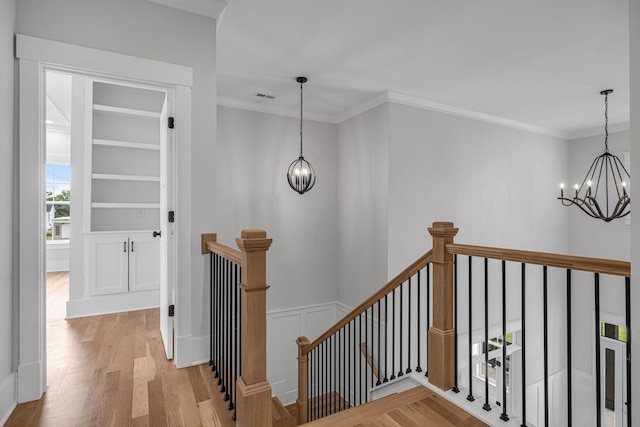 5937 Hunt Valley Dr, Spring Hill, TN 37174 - corridor featuring an upstairs landing, a chandelier, light wood-type flooring, and ornamental molding