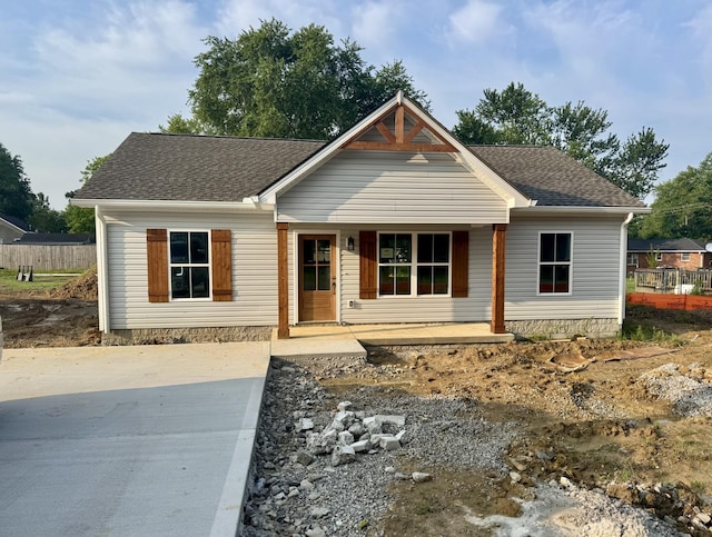 619 Wilson St, Greenbrier, TN 37073 - view of front facade featuring covered porch, a shingled roof, and driveway