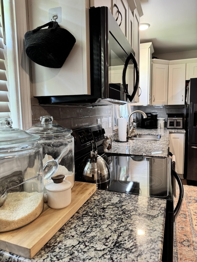 625 College Ave E, Carthage, TN 37030 - kitchen with black appliances, backsplash, white cabinets, and light stone countertops