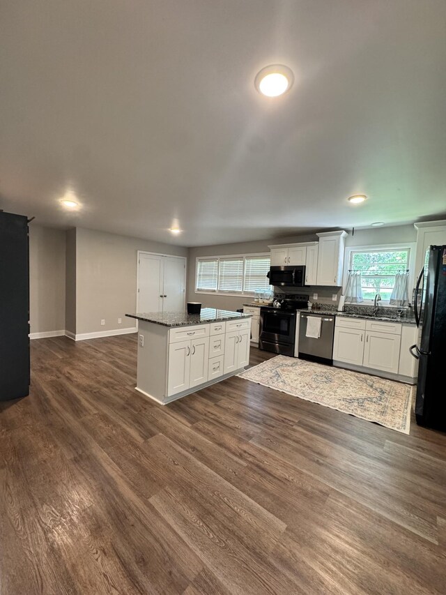 625 College Ave E, Carthage, TN 37030 - kitchen featuring black appliances, a center island, dark wood-style flooring, white cabinets, and dark stone countertops