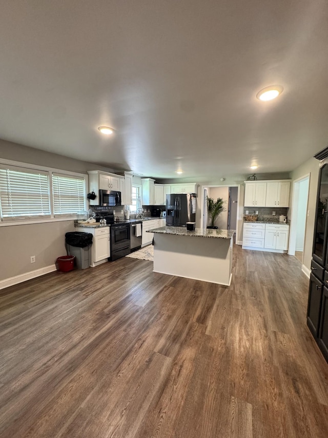 625 College Ave E, Carthage, TN 37030 - kitchen with black appliances, white cabinetry, dark wood-style flooring, and a center island