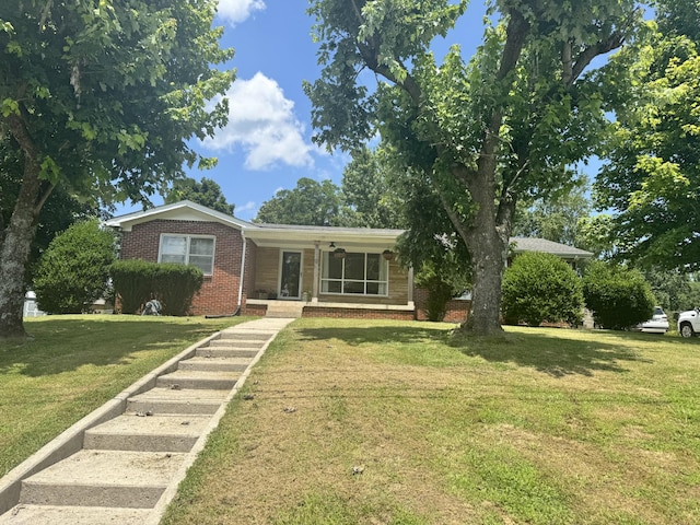 625 College Ave E, Carthage, TN 37030 - ranch-style home with brick siding, a front yard, and covered porch