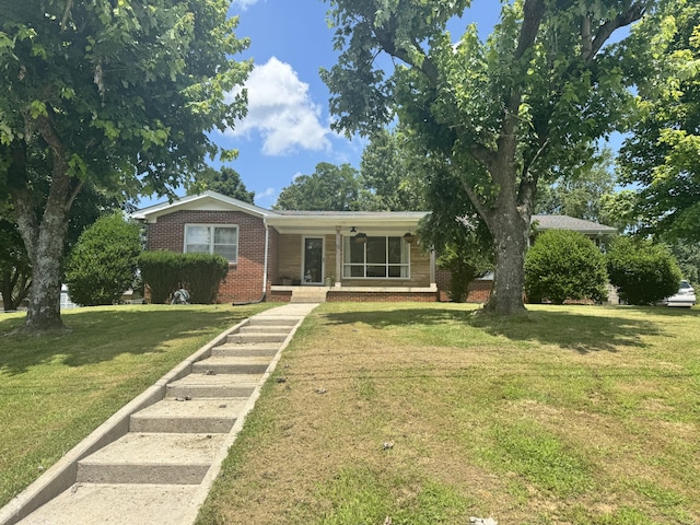 625 College Ave E, Carthage, TN 37030 - view of front of home featuring brick siding, a front lawn, and covered porch