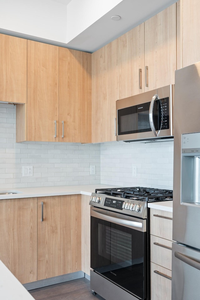 1212 Demonbreun St Unit A9 L, Nashville, TN 37203 - kitchen featuring stainless steel appliances, light brown cabinetry, light countertops, and modern cabinets
