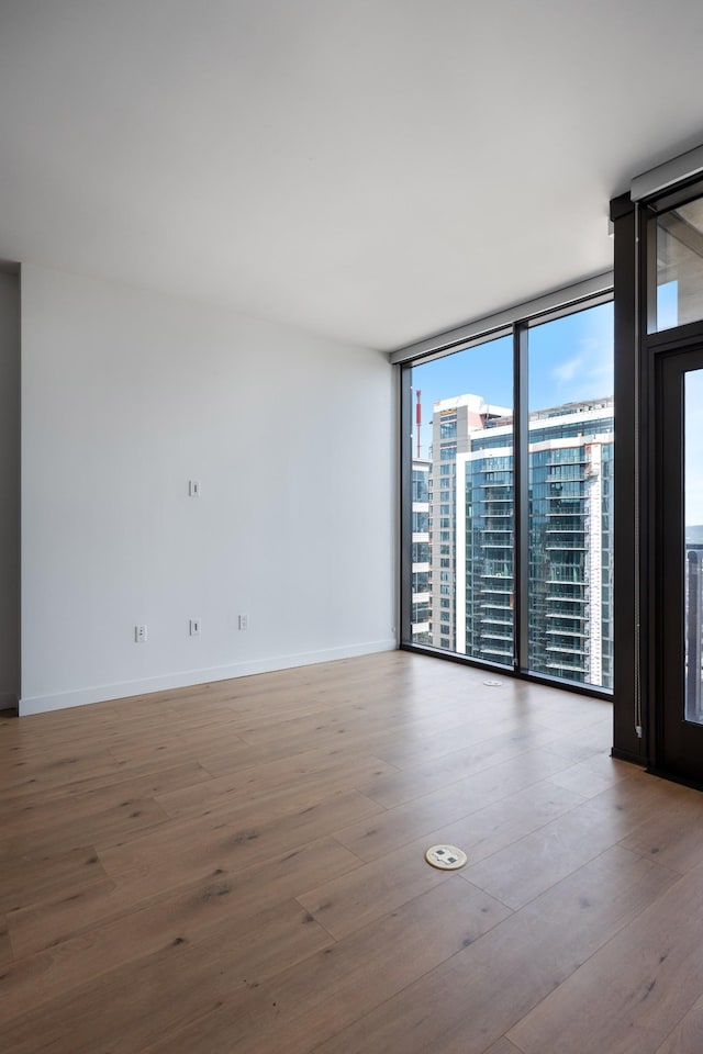 1212 Demonbreun St Unit A9 L, Nashville, TN 37203 - empty room with floor to ceiling windows and wood finished floors