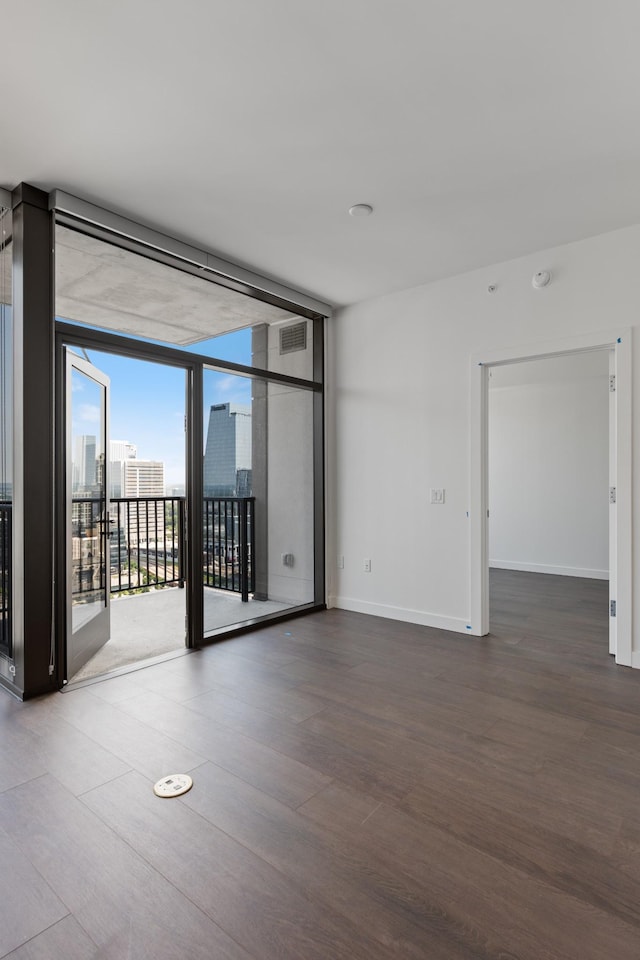 1212 Demonbreun St Unit A9 L, Nashville, TN 37203 - spare room with wood finished floors and floor to ceiling windows