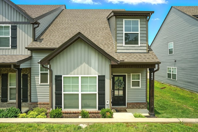 427 Rick Mccormick Dr, La Vergne, TN 37086 - view of front of house with board and batten siding, roof with shingles, and brick siding
