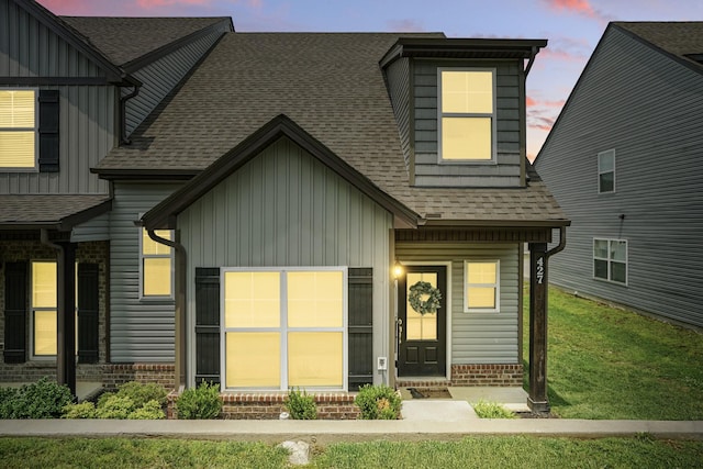 427 Rick Mccormick Dr, La Vergne, TN 37086 - view of front facade with board and batten siding, a shingled roof, and brick siding