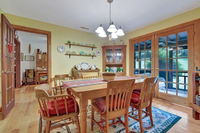 6861 Arno Allisona Rd, College Grove, TN 37046 - dining space with french doors, a chandelier, and light wood-style floors