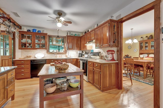 6861 Arno Allisona Rd, College Grove, TN 37046 - kitchen featuring white gas range, black dishwasher, light countertops, a ceiling fan, and a chandelier