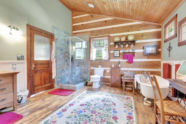 6861 Arno Allisona Rd, College Grove, TN 37046 - bathroom with wooden walls, a stall shower, a freestanding bath, wood finished floors, and vaulted ceiling