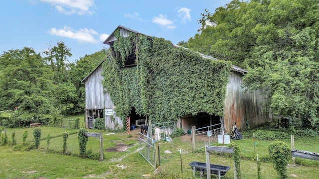 6861 Arno Allisona Rd, College Grove, TN 37046 - rear view of property with a barn, an outbuilding, and a lawn