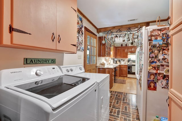 6861 Arno Allisona Rd, College Grove, TN 37046 - washroom featuring independent washer and dryer, brick patterned flooring, and cabinet space