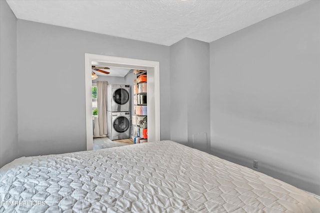 4616 Coile Rd, Knoxville, TN 37918 - bedroom with stacked washing machine and dryer and a textured ceiling