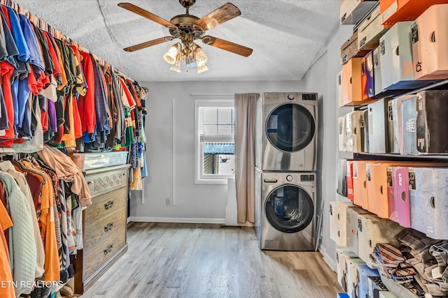 4616 Coile Rd, Knoxville, TN 37918 - washroom featuring stacked washer and clothes dryer, ceiling fan, light wood-style flooring, and a textured ceiling
