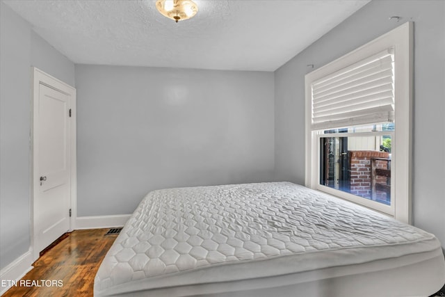 4616 Coile Rd, Knoxville, TN 37918 - bedroom featuring dark wood-style floors and a textured ceiling