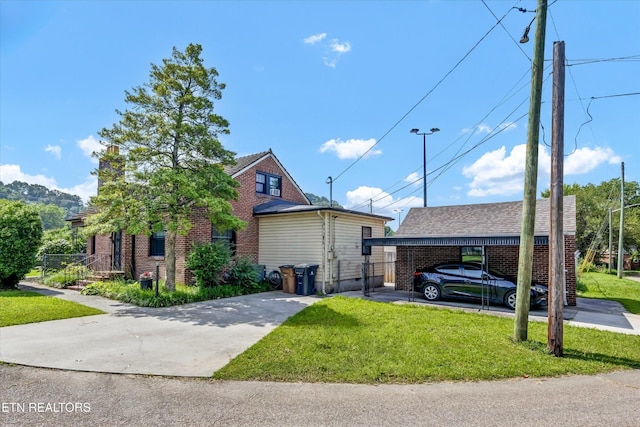 4616 Coile Rd, Knoxville, TN 37918 - view of side of property featuring a lawn, brick siding, and concrete driveway