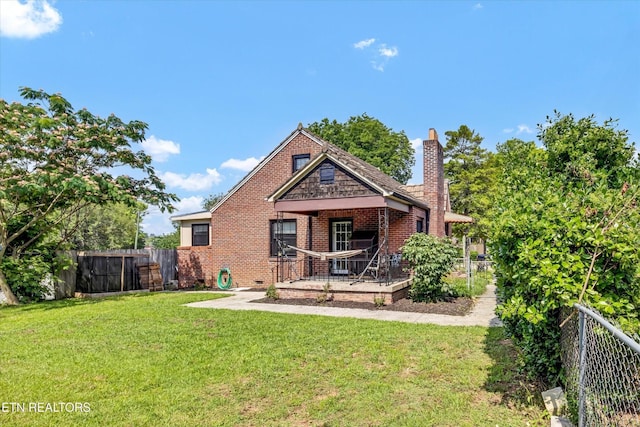 4616 Coile Rd, Knoxville, TN 37918 - back of property with a fenced backyard, a chimney, and brick siding