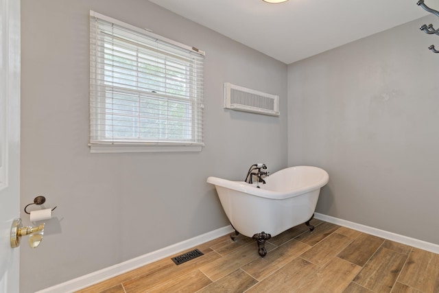 1111 Chickasaw Dr, Brentwood, TN 37027 - full bathroom with a freestanding bath, wood finished floors, and a wall mounted AC